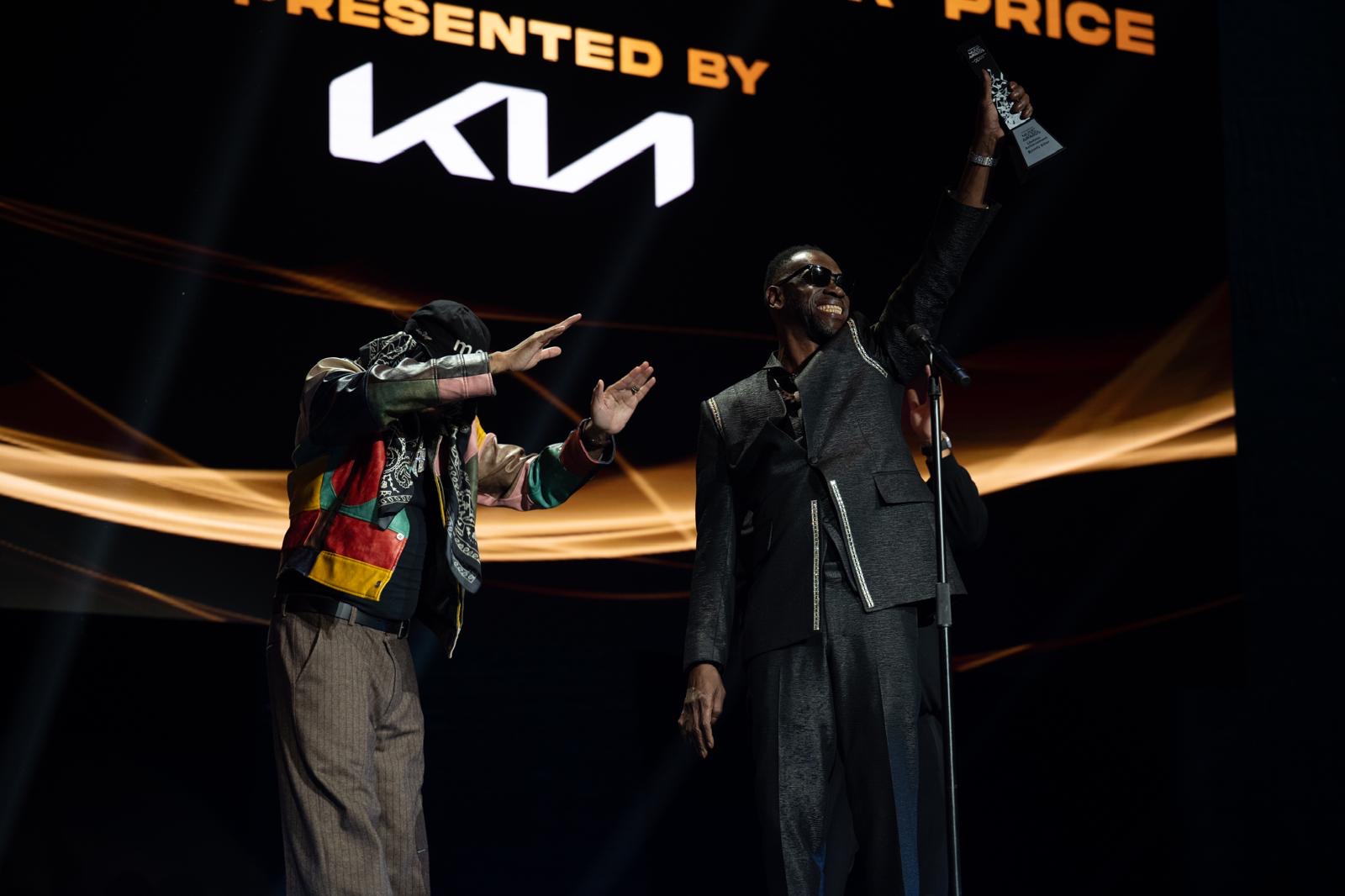 Two artists celebrate an award presentation at the Caribbean Music Awards