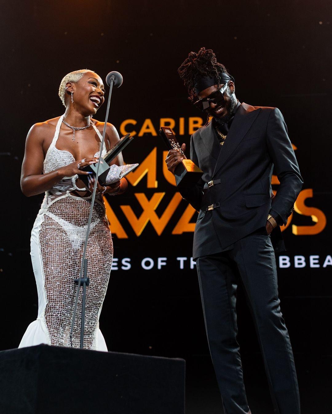 A Caribbean Music Awards winner celebrating on stage with his trophy