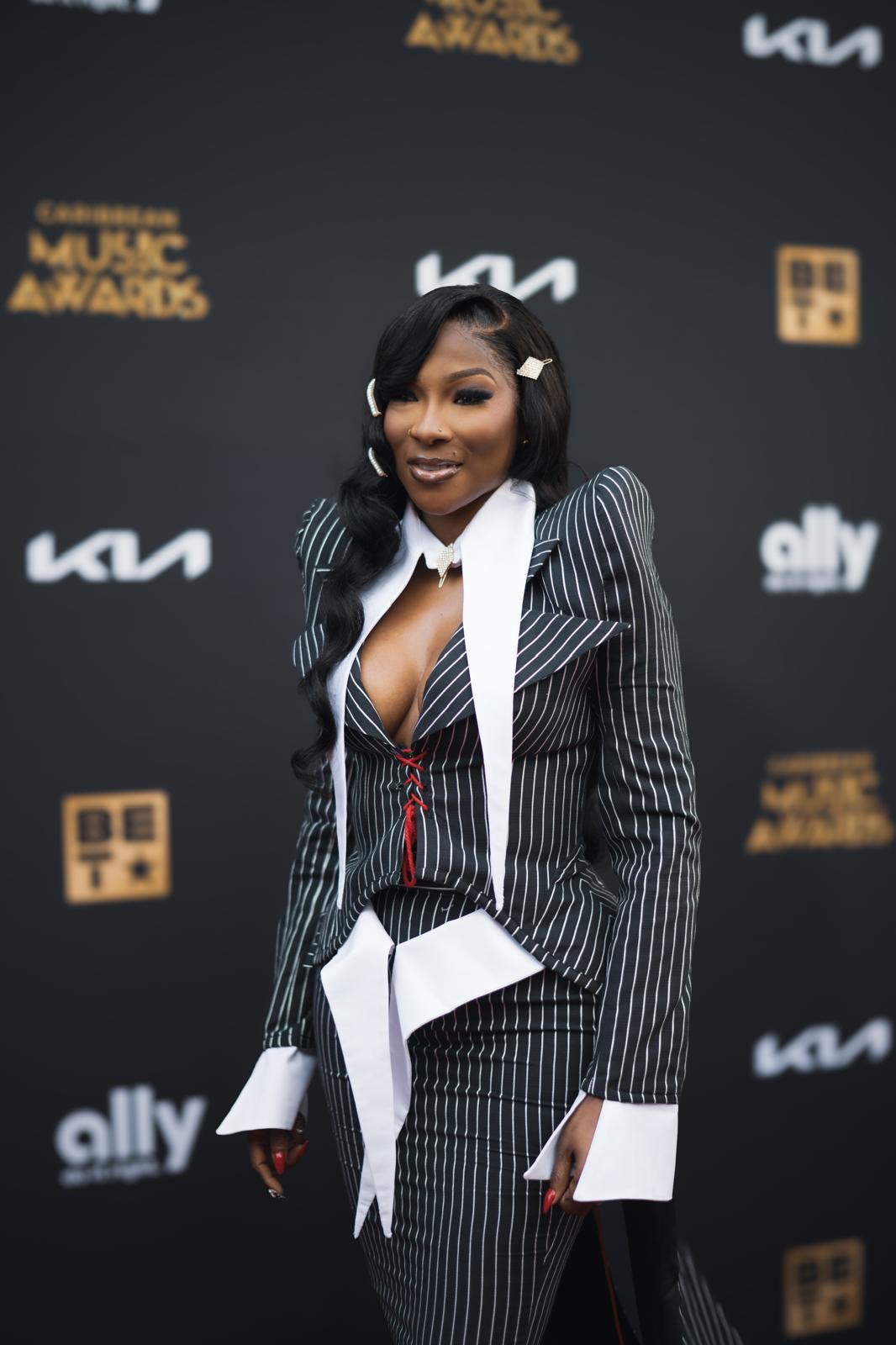 A guest in a pinstripe look at the 2026 Caribbean Music Awards red carpet