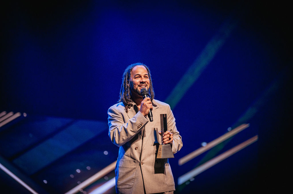 2026 Caribbean Music Awards artist speaking onstage with his award