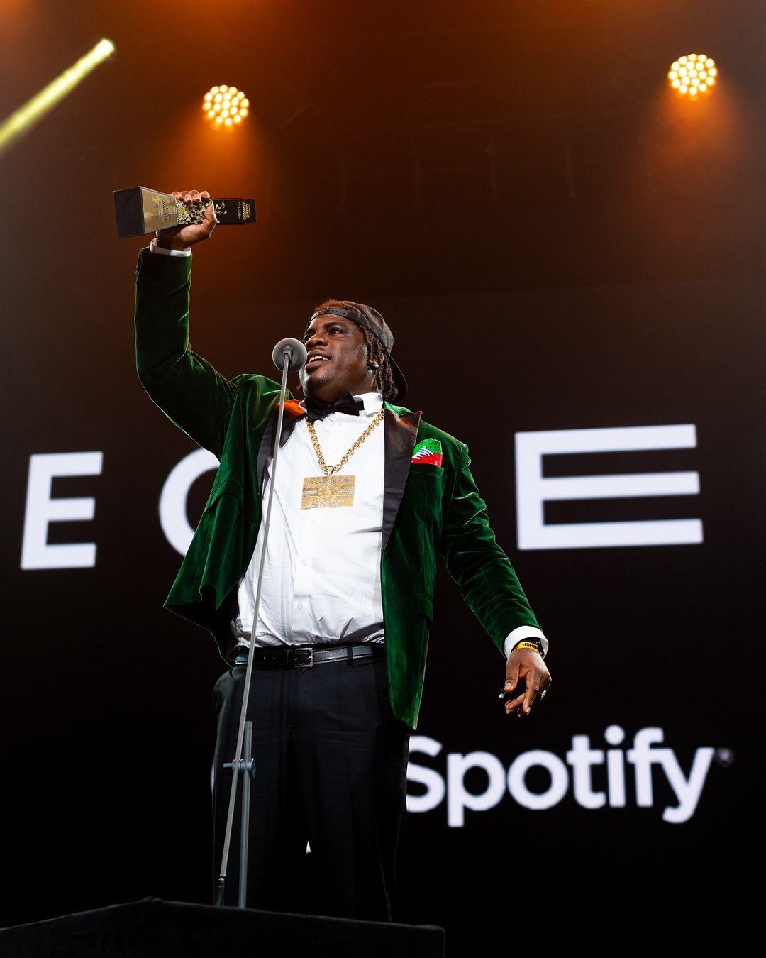 A winner raises a trophy at the Caribbean Music Awards