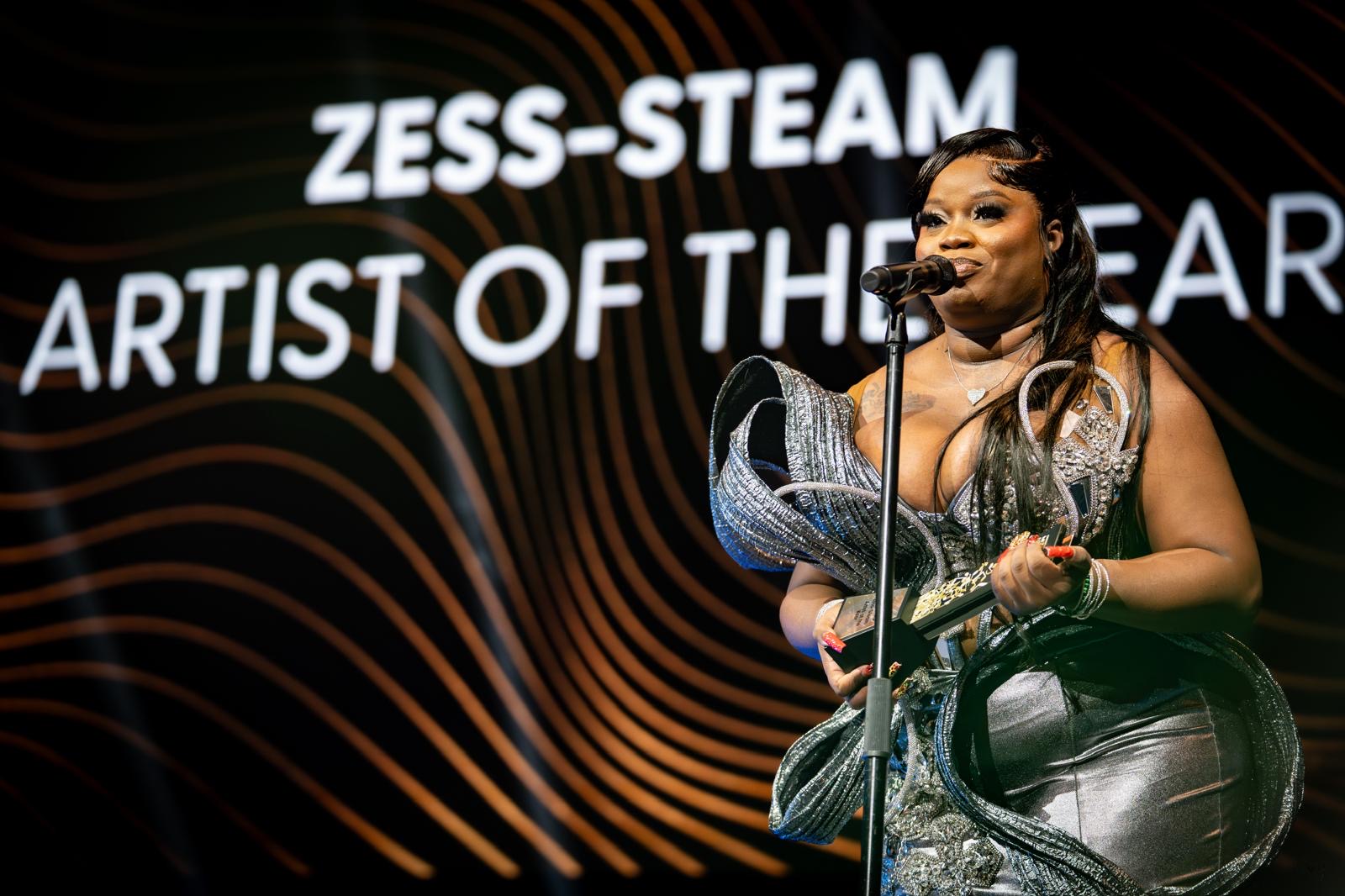 Zess-Steam accepts Artist of the Year at the Caribbean Music Awards stage